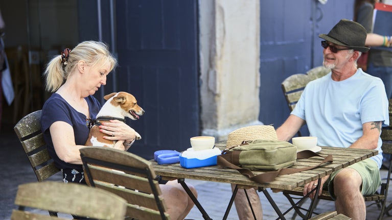 Visitors and their dog in the cafe at Attingham Park in Shropshire